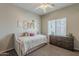 Bedroom with a decorative daybed, ceiling fan, carpeted floors, a dresser, and wall decor at 1482 S Banning St, Gilbert, AZ 85296