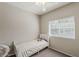 Cozy bedroom with a white twin bed, butterfly wall decals, a large window, and neutral walls at 1482 S Banning St, Gilbert, AZ 85296