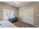 Bedroom featuring neutral walls, a ceiling fan, carpeted floors, a dresser, and a window at 1482 S Banning St, Gilbert, AZ 85296
