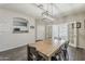 Elegant dining room with a large table, modern lighting, and stylish dark wood floors at 1482 S Banning St, Gilbert, AZ 85296