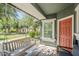 Charming covered porch with a swing, seating area, and views of the well-manicured front yard at 1482 S Banning St, Gilbert, AZ 85296
