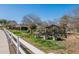 Community garden featuring neat rows of crops, raised garden beds, and white fencing at 1482 S Banning St, Gilbert, AZ 85296