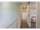 Well-lit hallway with neutral walls leads to a bedroom with a sliding door at 1482 S Banning St, Gilbert, AZ 85296