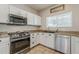 Well-lit kitchen features stainless steel appliances, stylish hardware, and granite countertops at 1482 S Banning St, Gilbert, AZ 85296
