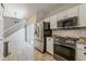 Well-lit kitchen with stainless steel appliances and sliding glass doors to the backyard at 1482 S Banning St, Gilbert, AZ 85296