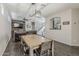 Open-concept living space with dark wood floors, a rustic accent wall, and ample seating at 1482 S Banning St, Gilbert, AZ 85296