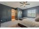 Comfortable main bedroom with a ceiling fan, neutral carpet, and a window at 1482 S Banning St, Gilbert, AZ 85296
