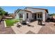 Backyard with a fire pit seating area and low-maintenance artificial grass at 15407 W Windrose Dr, Surprise, AZ 85379