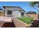 Backyard with artificial grass, a hammock, and gravel accents at 15407 W Windrose Dr, Surprise, AZ 85379
