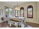 Bright dining room with a chandelier and ample windows, creating an inviting space at 15407 W Windrose Dr, Surprise, AZ 85379