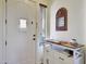 Bright entryway features a stylish console table, decorative mirror, and a classic white door at 15407 W Windrose Dr, Surprise, AZ 85379