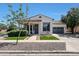 Charming single-story home featuring a tile roof, manicured landscaping, and attached two-car garage at 15407 W Windrose Dr, Surprise, AZ 85379