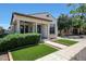 Inviting single-story home with manicured lawn, covered porch with columns, and neutral color palette at 15407 W Windrose Dr, Surprise, AZ 85379