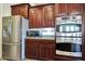 Gourmet kitchen showcasing stainless steel appliances, including a built-in oven and microwave at 15407 W Windrose Dr, Surprise, AZ 85379