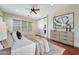 Bright main bedroom featuring a barn door to ensuite and a neutral color palette at 15407 W Windrose Dr, Surprise, AZ 85379
