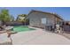 A well-maintained backyard featuring a kidney-shaped pool, an air conditioner unit, and an easy-to-maintain landscape at 15905 W Saguaro Ln, Surprise, AZ 85374