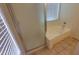 Modern bathroom with a standalone tub, complemented by a frosted glass shower door and natural light at 15905 W Saguaro Ln, Surprise, AZ 85374