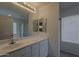 Well-lit bathroom features a vanity with bright lighting and a large mirror at 15905 W Saguaro Ln, Surprise, AZ 85374