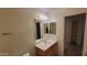 A clean bathroom with a vanity, sink, and a mirror providing essential convenience and functionality at 15905 W Saguaro Ln, Surprise, AZ 85374