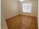 A comfortable bedroom featuring hardwood floors and a window, creating a welcoming private space at 15905 W Saguaro Ln, Surprise, AZ 85374