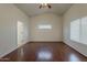 Bright bedroom has wood floors, a ceiling fan and views through the window at 15905 W Saguaro Ln, Surprise, AZ 85374