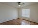 This bright bedroom features hardwood floors and a window for natural light at 15905 W Saguaro Ln, Surprise, AZ 85374