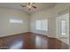 Spacious bedroom with a ceiling fan and beautiful wood-style flooring at 15905 W Saguaro Ln, Surprise, AZ 85374
