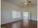 Bedroom features wood-style flooring and double doors to an adjoining room at 15905 W Saguaro Ln, Surprise, AZ 85374