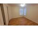 A cozy bedroom with hardwood floors, natural light, and a closet offers a comfortable and private retreat at 15905 W Saguaro Ln, Surprise, AZ 85374