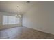 Bright dining room featuring tile flooring, a chandelier, and a large window at 15905 W Saguaro Ln, Surprise, AZ 85374