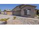 Inviting single-story home with a two-car garage and attractive desert landscaping at 15905 W Saguaro Ln, Surprise, AZ 85374