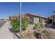 Attractive single-story house with desert landscaping and block wall at 15905 W Saguaro Ln, Surprise, AZ 85374