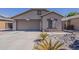 Charming single-story home with a two-car garage and desert landscaping at 15905 W Saguaro Ln, Surprise, AZ 85374