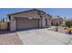 Single-story home featuring a two-car garage and low-maintenance desert landscaping at 15905 W Saguaro Ln, Surprise, AZ 85374