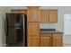Kitchen cabinetry detail showing a black fridge and good storage space at 15905 W Saguaro Ln, Surprise, AZ 85374