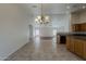 Bright kitchen and living room area with tile flooring and modern appliances at 15905 W Saguaro Ln, Surprise, AZ 85374