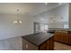 Open kitchen features an island, tile floors, and views into the living room at 15905 W Saguaro Ln, Surprise, AZ 85374