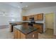 Bright kitchen with tile flooring, wooden cabinets, a large island and stainless steel appliances at 15905 W Saguaro Ln, Surprise, AZ 85374