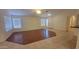 A bright living room with wood flooring, neutral walls, and windows that brings in natural light at 15905 W Saguaro Ln, Surprise, AZ 85374