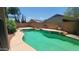 Inviting pool area with clear water, surrounded by a low brick wall, and potted plants enhancing the outdoor space at 15905 W Saguaro Ln, Surprise, AZ 85374