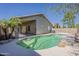 Backyard pool featuring rock accents, a covered patio, and a well-maintained surrounding area at 15905 W Saguaro Ln, Surprise, AZ 85374