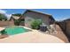 Backyard with a refreshing pool, lush landscaping, and an integrated AC unit for outdoor enjoyment at 15905 W Saguaro Ln, Surprise, AZ 85374
