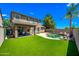 Home exterior showcases a pool, covered patio, manicured lawn, and ample space for outdoor living at 18045 W Rimrock St, Surprise, AZ 85388