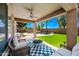 Backyard oasis with a covered patio, outdoor seating area, and a lush, inviting pool at 18045 W Rimrock St, Surprise, AZ 85388