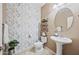 Charming powder room with patterned wallpaper, pedestal sink, and decorative mirror at 18045 W Rimrock St, Surprise, AZ 85388