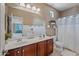 Spacious bathroom featuring a double vanity, large mirror, and shower with a clean, modern design at 18045 W Rimrock St, Surprise, AZ 85388