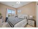 Bedroom with a large window offering plenty of natural light and views of the neighborhood at 18045 W Rimrock St, Surprise, AZ 85388