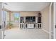 Well-lit bedroom with entertainment center, neutral walls, plush carpeting and large window at 18045 W Rimrock St, Surprise, AZ 85388