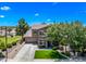 Charming two-story home with well-manicured lawn, mature trees and a welcoming front entrance at 18045 W Rimrock St, Surprise, AZ 85388