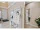 Inviting foyer with hall tree, neutral tile flooring, and views to the living spaces at 18045 W Rimrock St, Surprise, AZ 85388